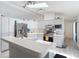 Bright kitchen featuring stainless steel appliances, white cabinets, and a breakfast bar at 12087 Tallwood St, Spring Hill, FL 34608