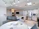Open-concept kitchen and living area with a fireplace, stainless steel appliances, and ample natural light at 12087 Tallwood St, Spring Hill, FL 34608