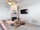 Cozy living room featuring a fireplace, mounted TV, neutral decor, and comfortable seating at 12087 Tallwood St, Spring Hill, FL 34608