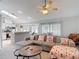 Open-concept living room with kitchen views, showcasing natural light, and comfortable seating arrangements at 12087 Tallwood St, Spring Hill, FL 34608