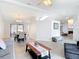 Open concept living space featuring wood-look flooring, modern furnishings and a fireplace at 12087 Tallwood St, Spring Hill, FL 34608
