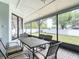 Spacious screened-in patio with ample seating and a backyard view at 12087 Tallwood St, Spring Hill, FL 34608