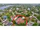 Aerial view of a single-Gathering home nestled in a neighborhood surrounded by lush greenery and waterways at 1218 Castle Ter, Tarpon Springs, FL 34689