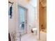 This light bathroom features a shower, a door to the exterior and a large window at 1218 Castle Ter, Tarpon Springs, FL 34689