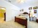 Bright bedroom features a ceiling fan, closet space, and a comfortable bed with soft, neutral-colored bedding at 1218 Castle Ter, Tarpon Springs, FL 34689
