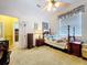 Bright bedroom features a ceiling fan, a window, and a comfortable bed with soft, neutral-colored bedding at 1218 Castle Ter, Tarpon Springs, FL 34689