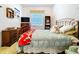 Cozy bedroom with metal frame bed, patterned quilt, dresser, and window at 1218 Castle Ter, Tarpon Springs, FL 34689
