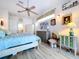 Primary bedroom with wood flooring, ceiling fan, dresser, lamps, and plenty of natural light at 1218 Castle Ter, Tarpon Springs, FL 34689