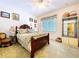 Charming bedroom with a ceiling fan, a window, and a comfortable bed with soft, neutral-colored bedding at 1218 Castle Ter, Tarpon Springs, FL 34689