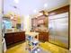 Modern kitchen with stainless steel appliances, granite countertops, and wooden cabinets, offering ample storage space at 1218 Castle Ter, Tarpon Springs, FL 34689