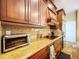 Well-equipped kitchen featuring granite counters, wood cabinets, and modern appliances at 1218 Castle Ter, Tarpon Springs, FL 34689