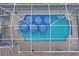 Aerial view of a screened-in in-ground swimming pool and patio on the back of a shingled roof home at 12300 Drake Ln, Spring Hill, FL 34609