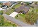Aerial view of a single-Gathering home with a screened lanai, spacious yard, and decorative driveway at 12300 Drake Ln, Spring Hill, FL 34609