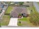 Overhead aerial view of a well-maintained home featuring a large, fenced yard and custom driveway at 12300 Drake Ln, Spring Hill, FL 34609