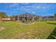 Home with a screened-in pool and garden in the backyard at 12300 Drake Ln, Spring Hill, FL 34609