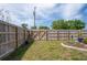 Fenced backyard with landscaped garden bed featuring plants and mulch at 12300 Drake Ln, Spring Hill, FL 34609