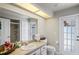 Bathroom featuring a single sink vanity, toilet, and tiled shower with glass door at 12300 Drake Ln, Spring Hill, FL 34609