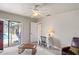 Bedroom with sliding door access to a sunroom and a desk with a floral lamp at 12300 Drake Ln, Spring Hill, FL 34609
