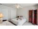 Cozy bedroom with ceiling fan, double closets, and a privacy screen at 12300 Drake Ln, Spring Hill, FL 34609