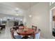 Breakfast nook with a fireplace, wooden table, and pool view creates a cozy, inviting space at 12300 Drake Ln, Spring Hill, FL 34609