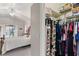 View from a walk-in closet into the bright main bedroom featuring a sliding glass door to the pool at 12300 Drake Ln, Spring Hill, FL 34609