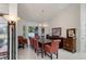 Bright dining room features a large table, red leather chairs, a chandelier and ample natural light at 12300 Drake Ln, Spring Hill, FL 34609
