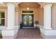 Grand entrance with tiled floor, pillars, and double doors at 12300 Drake Ln, Spring Hill, FL 34609