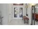 Bright foyer with tiled floors, a decorative door, and a bench at 12300 Drake Ln, Spring Hill, FL 34609
