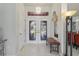 Inviting entryway with decorative glass doors and neutral tile flooring at 12300 Drake Ln, Spring Hill, FL 34609