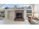 Close-up of the beautiful stone fireplace and mantel adding charm to the bright living room at 12300 Drake Ln, Spring Hill, FL 34609