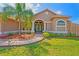 Charming home featuring a well-manicured lawn and palm tree at 12300 Drake Ln, Spring Hill, FL 34609