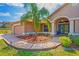 Inviting home exterior with palm tree and manicured landscaping at 12300 Drake Ln, Spring Hill, FL 34609