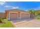 Home exterior featuring a three car garage and manicured lawn at 12300 Drake Ln, Spring Hill, FL 34609
