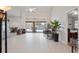 Open-concept living room featuring tile floors and sliding glass doors leading to the pool area at 12300 Drake Ln, Spring Hill, FL 34609
