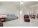 Open living space with vaulted ceilings, tile floors, ceiling fan, and easy access to other rooms at 12300 Drake Ln, Spring Hill, FL 34609