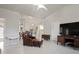 Spacious living room with a chair and ottoman, tile flooring, and open layout, perfect for modern living at 12300 Drake Ln, Spring Hill, FL 34609