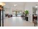 Spacious living room with high ceilings, tile floors, and sliding doors to the pool at 12300 Drake Ln, Spring Hill, FL 34609