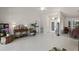 Spacious living room filled with natural light, featuring tile flooring and an elegant entryway at 12300 Drake Ln, Spring Hill, FL 34609