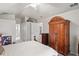 Airy primary bedroom with a decorative wood bed frame, neutral walls, and access to the ensuite bathroom at 12300 Drake Ln, Spring Hill, FL 34609
