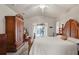 Comfortable main bedroom showcasing a decorative wood bed frame, ceiling fan, and screened patio access at 12300 Drake Ln, Spring Hill, FL 34609