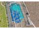 Aerial view of a screened-in in-ground swimming pool and patio on the back of a shingled roof home at 12300 Drake Ln, Spring Hill, FL 34609