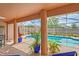 An inviting in-ground swimming pool is surrounded by colorful foliage and a screened enclosure at 12300 Drake Ln, Spring Hill, FL 34609