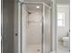 Corner shower with glass enclosure featuring a handheld shower head and tiled walls at 12300 Drake Ln, Spring Hill, FL 34609