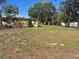 A spacious grassy backyard featuring mature trees surrounding the property at 1332 Inca Ave, Spring Hill, FL 34608