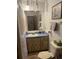 Bathroom vanity with blue countertop, and a light wood vanity with a view of the toilet at 1332 Inca Ave, Spring Hill, FL 34608