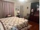 Cozy bedroom featuring a comfortable bed with a floral patchwork quilt at 1332 Inca Ave, Spring Hill, FL 34608