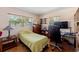 This cozy bedroom features tile floors, a window, and a ceiling fan at 13811 Michelle Ave, Hudson, FL 34667