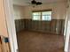 Bedroom under renovation with wood-look tile flooring and natural light from a window at 13811 Michelle Ave, Hudson, FL 34667