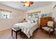 The cozy bedroom features wood-look tile and lots of natural light at 13811 Michelle Ave, Hudson, FL 34667