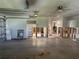 A look at the large garage space featuring a roll-up door and access to multiple rooms at 13811 Michelle Ave, Hudson, FL 34667